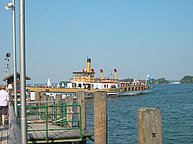 Paddle Wheel ferry boat Ludwig Fessler pulling in to dock on the lake of Chiemsee.