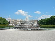 The fountain of turtles and frogs with Herren Chiemsee in the background.